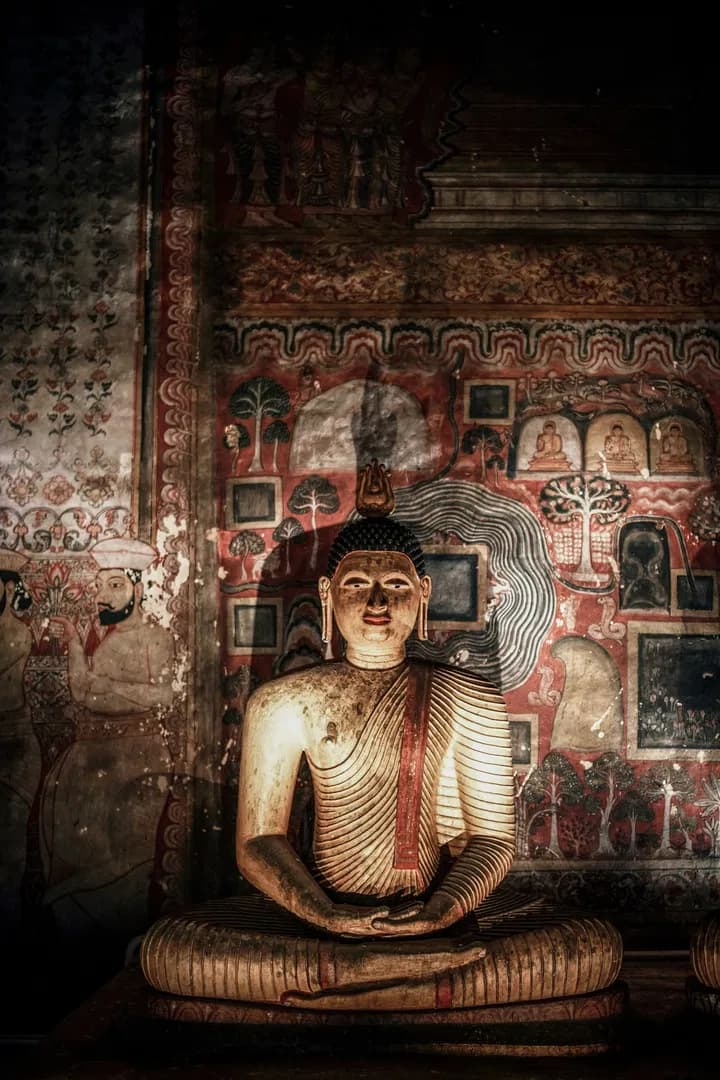 Ancient Buddha statue in decorated cave shrine